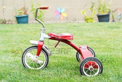 9747731-old-red-kids-bike-on-the-grass.jpg